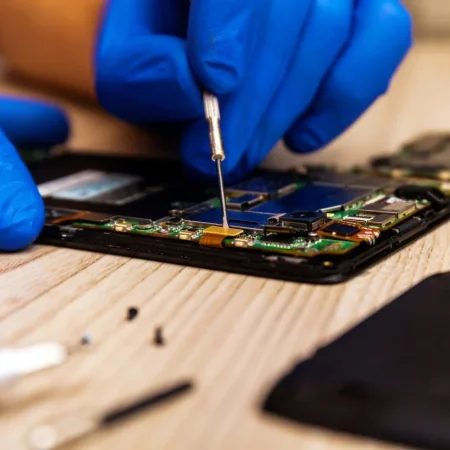 the-technician-repairing-the-smartphone-s-motherboard-in-the-workshop-on-the-table-