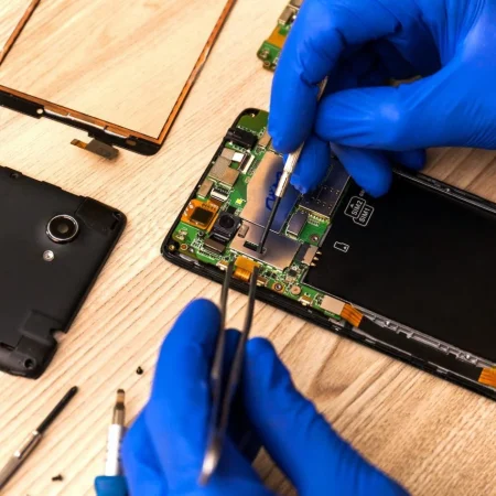 the-technician-repairing-the-smartphone-s-motherboard-in-the-workshop-on-the-table-1-1